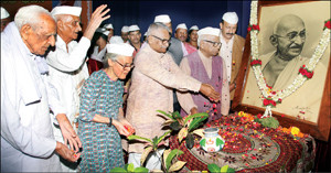 Senior advocate Prof. Ravi Verma Kumar is seen offering floral tributes to the portrait of Mahatma Gandhi at Senate Bhavan in Manasagangotri this morning as Gandhians Dr. H.S. Doreswamy, Dr. G. Madegowda, Shanthi N. Badriah, Dr. H. Srinivasaiah, Mysore University Gandhi Bhavan Director Prof. S. Shivarajappa and others look on. 