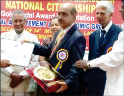 Dr. P.D. Padmakumar (second from left) is seen receiving the award from former Union Minister M.V. Rajashekharan (extreme left) as others look on. 