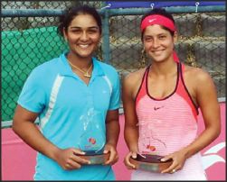 Dhruthi T. Venugopal (left) and Kyra Shroff who won the women's doubles title in the Mary Pierce Indian Ocean Series ITF Women's Tennis Tournament at Mauritius, seen with the winners' trophy. 