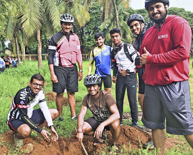 Members of the Mangalore Bicycle Club planting saplings at Baikampady Industrial Estate in Mangaluru on Sunday.—Photo: special arrangement 