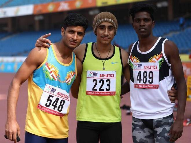 Champions all: Bhupender Singh, flanked by silver medallist C. Praveen, right, and Mohd Shahrukh strikes a pose after claiming the long jump gold on Thursday. bbfd 