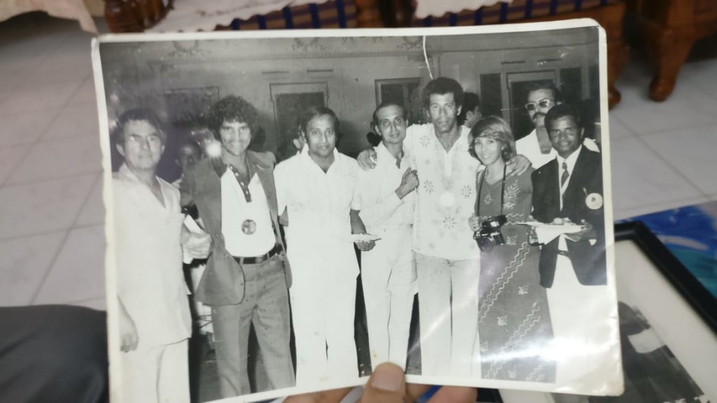 Arumainayagam in blazer and tie on the extreme right. The photo was taken at a party with Cosmos Team players from the USA when they played with Mohun Bagan team at Calcutta in 1977. Mr Pele also played the match and joined the party later. Mr Muthuraman, film actor third from the left is also seen. The match was played on 24th September 1977 at Eden Garden, Calcutta. The result was 2-2