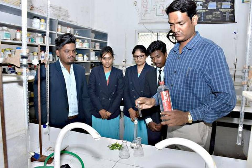 Harishchandra S. Bidnoorkar with his students in the laboratory at Sharnbasva University in Kalaburagi. 