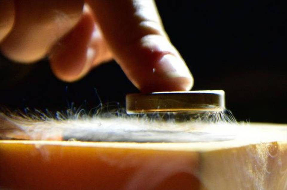 When a material is cooled below the superconducting transition temperature in a magnetic field it expels magnetic flux thereby appearing to levitate.   | Photo Credit: AFP